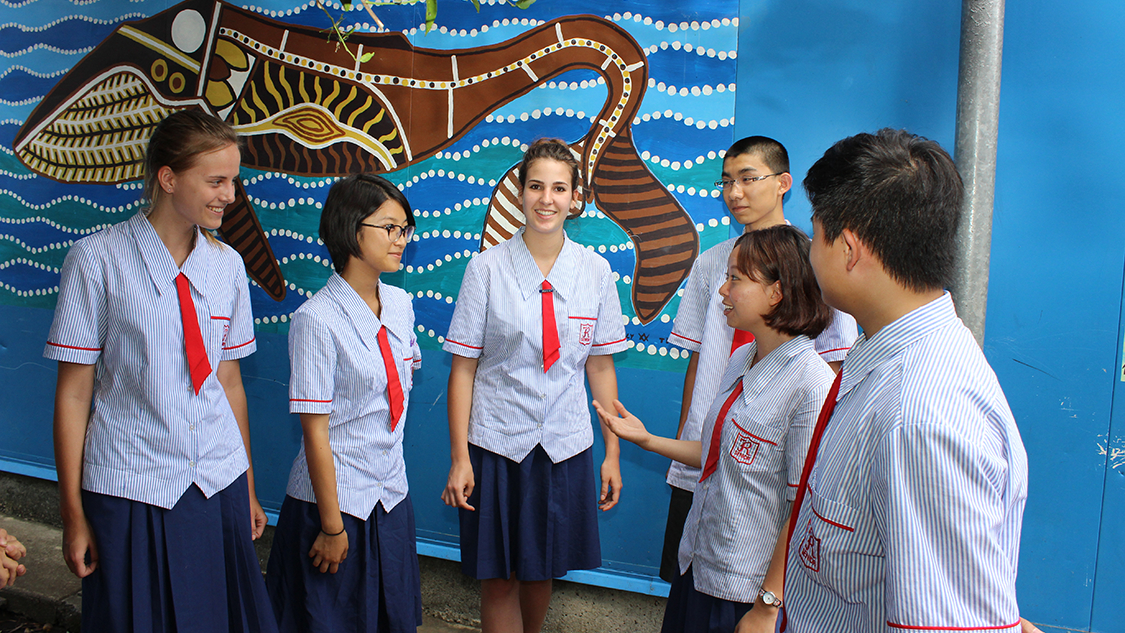 Students in front of Aboriginal artwork