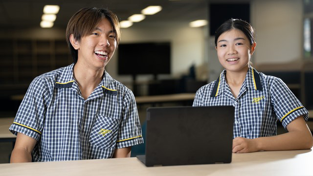 Two students sitting at a table.