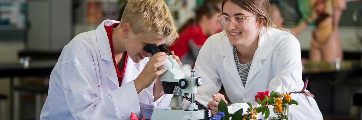 Science students using a microscope