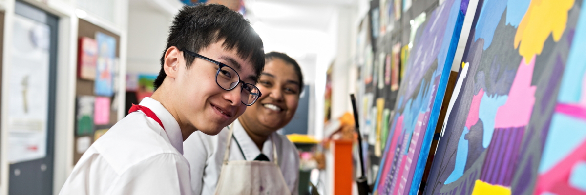 Students painting in an art room